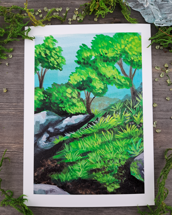 An image of a 5"x7" mini print surrounded by green crystals and moss. The mini print features a landscape with rocks, trees and grass, which was painted with acrylic inks.