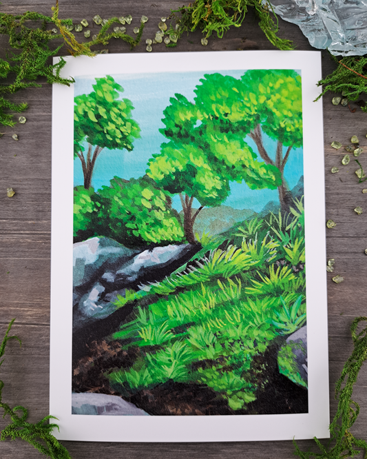 An image of a 5"x7" mini print surrounded by green crystals and moss. The mini print features a landscape with rocks, trees and grass, which was painted with acrylic inks.